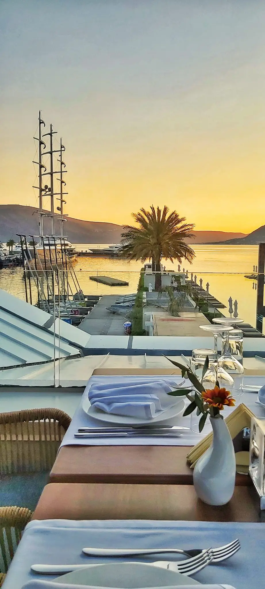 Dinner table set at sunset by the marina in Porto Montenegro, Tivat