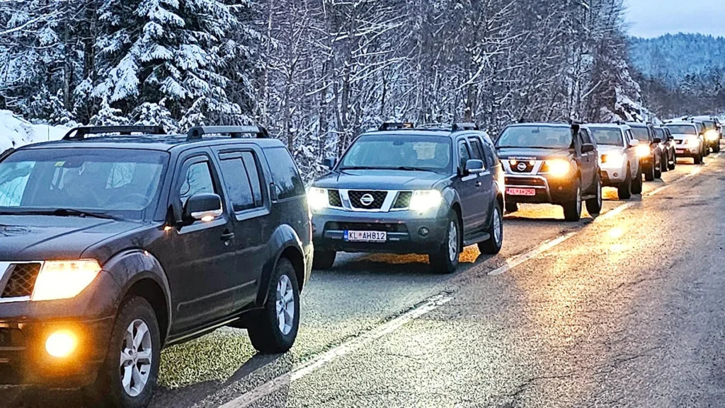 Convoy of 4x4 vehicles on a VIP transfer in Montenegro, on a snowy road near Kolašin