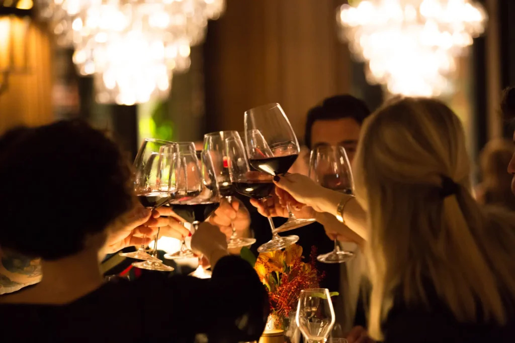 Guests toasting with wine glasses at a private celebration in Montenegro, arranged by Zeta Travel