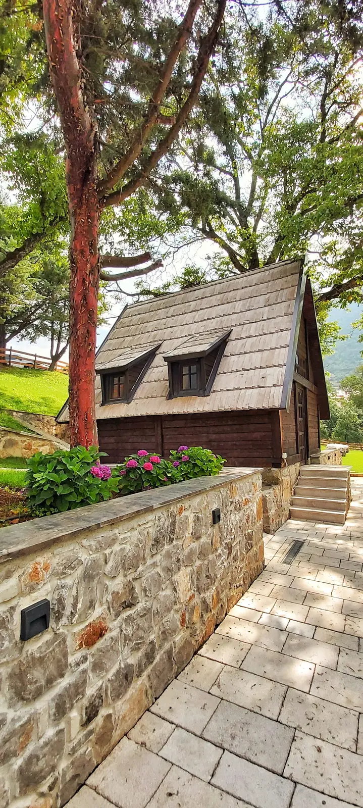 Traditional wooden mountain cabin with stone terrace near Piva Lake in northern Montenegro