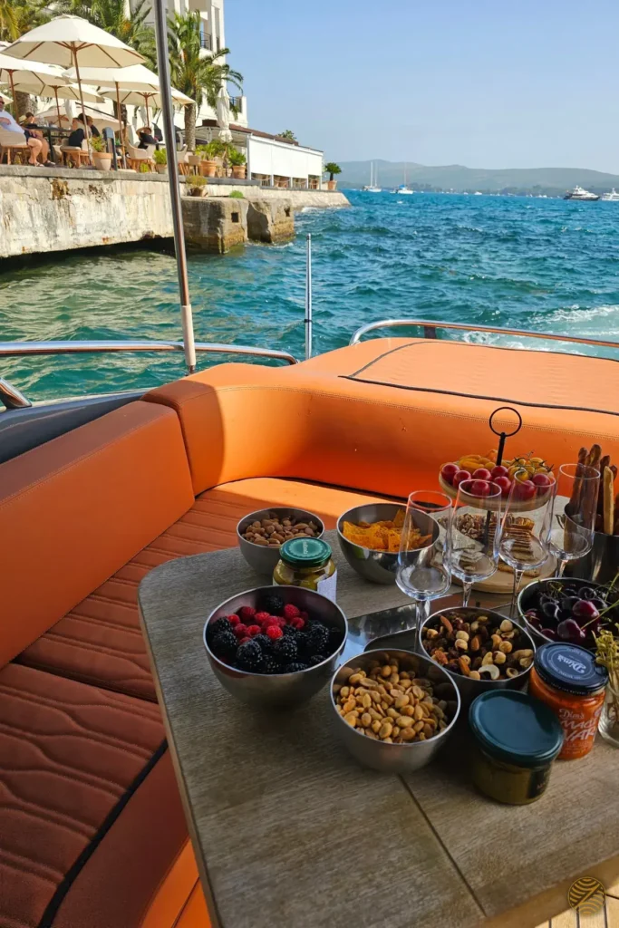 Fruit, nuts and glasses set for an aperitivo on a private speedboat off Porto Montenegro, Tivat