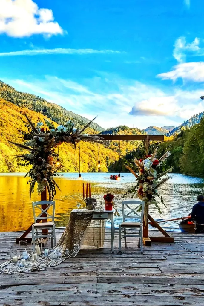 Wedding arch on a wooden pier by a mountain lake, set up for a wedding in Montenegro