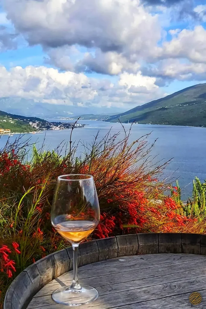 A glass of local wine on an old barrel above the Bay of Kotor